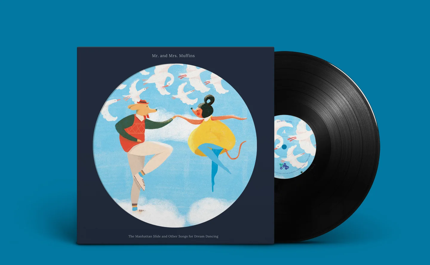 Mr. and Mrs. Muffins, “The Manhattan Slide and Other Songs for Dream Dancing”: a navy sleeve with a round illustration of a dog in a cardigan and a mouse in a yellow skirt dancing among clouds and geese, beside its vinyl record.
